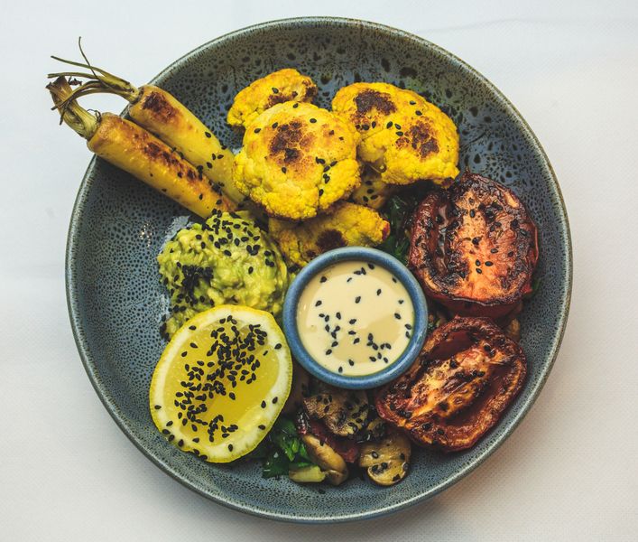 Grain bowl with roasted vegetables and tahini